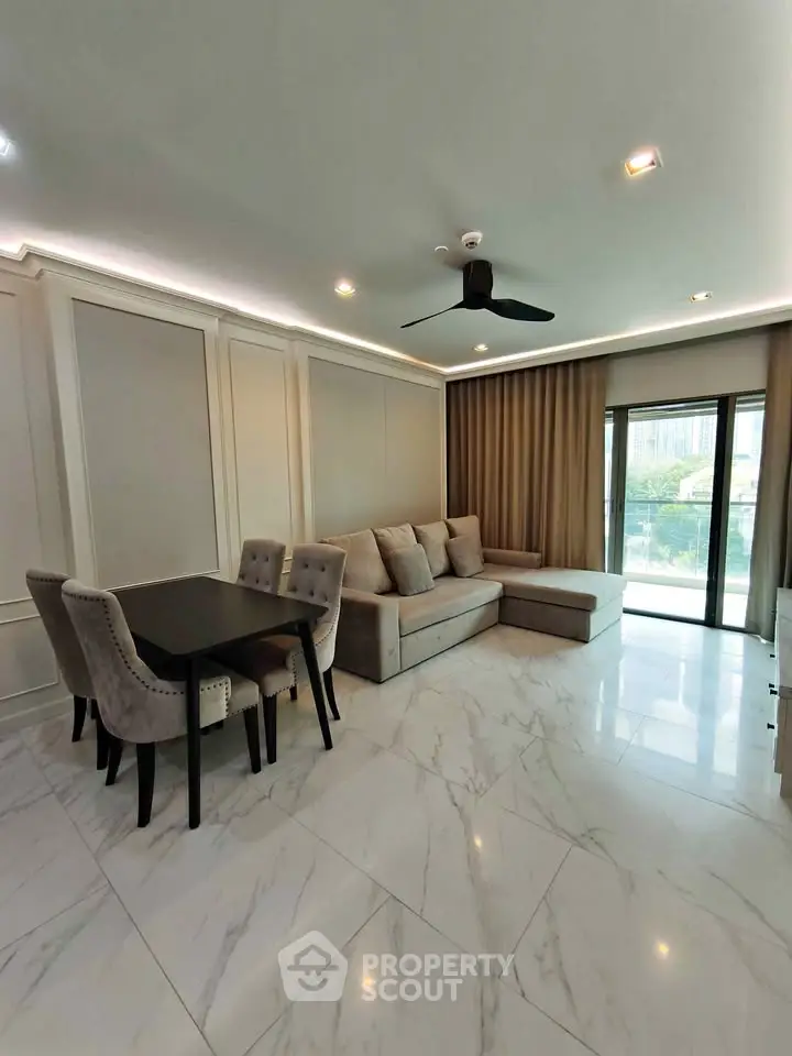 Elegant living room with modern decor, featuring a cozy sofa, dining set, and large windows with city view.