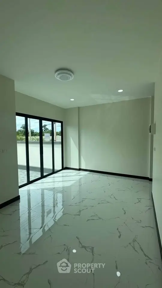 Spacious empty room with large windows and marble flooring, perfect for customization.