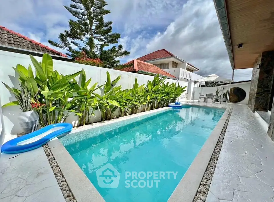 Stunning private pool with lush greenery and modern design, perfect for relaxation and entertainment.