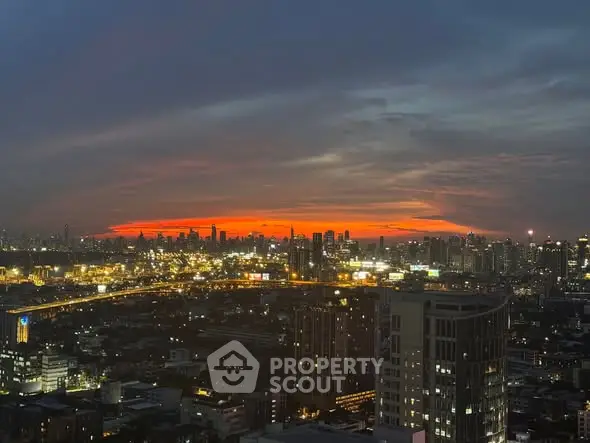 Stunning city skyline view at sunset with vibrant orange horizon.