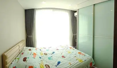 Cozy bedroom with bright window and sliding closet doors