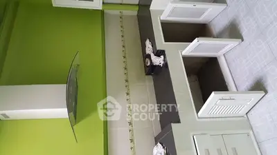 Modern kitchen with vibrant green walls and sleek cabinetry