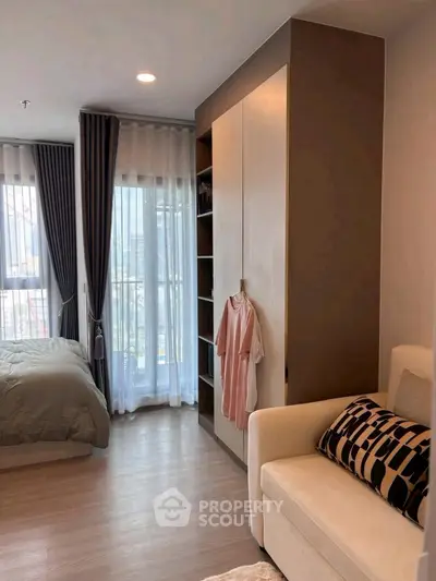 Modern bedroom with stylish decor and large windows for natural light