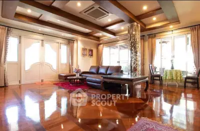 Luxurious living room with polished wooden floors and elegant decor