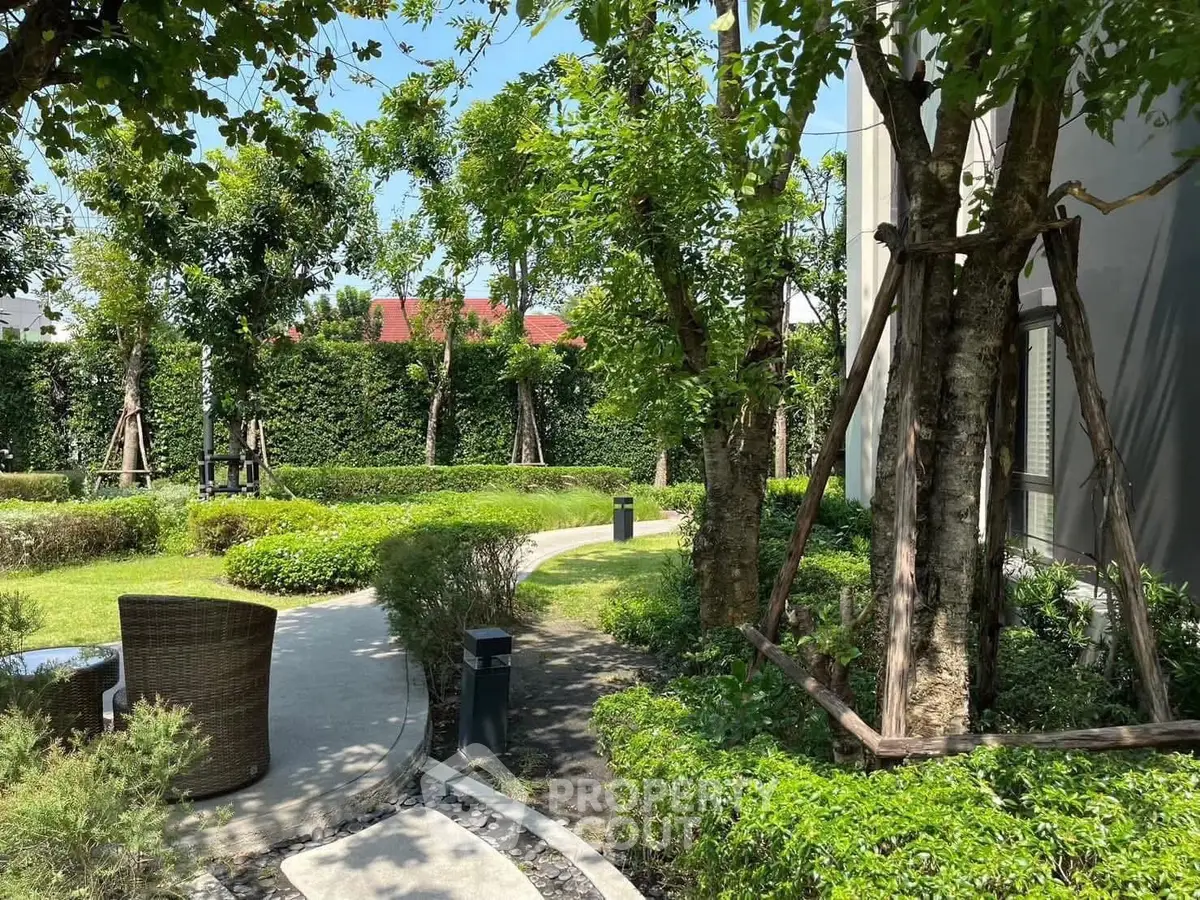 Lush garden area with winding path and seating, perfect for relaxation and outdoor enjoyment.
