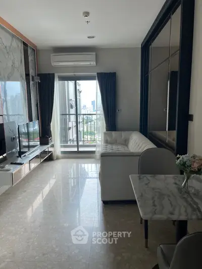 Modern living room with balcony view, featuring sleek marble floors and stylish furniture.