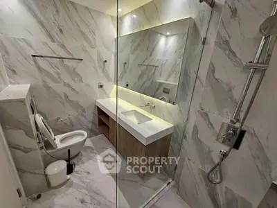 Luxurious marble bathroom with modern fixtures and elegant lighting