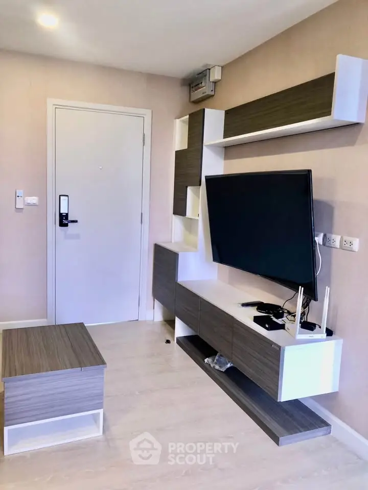 Modern living room with sleek TV unit and stylish furniture in a contemporary apartment.