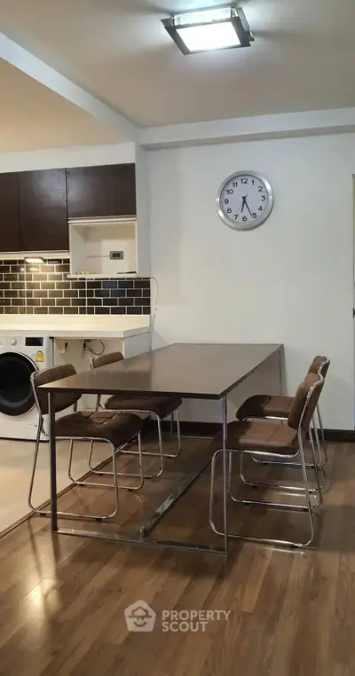 Modern kitchen with sleek dining area and integrated appliances