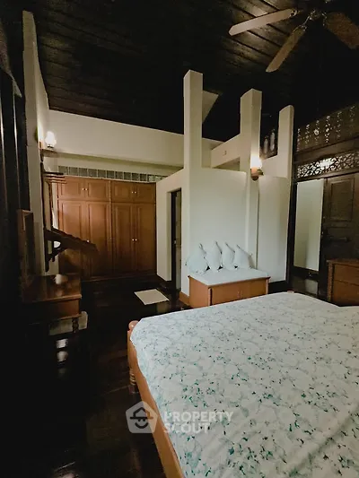 Charming bedroom with wooden accents and cozy decor in a serene setting.