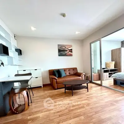 Modern living room with stylish furniture and wooden flooring in a cozy apartment.