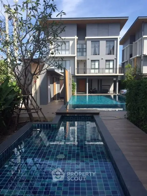 Luxurious modern townhouse with private pool and lush garden view