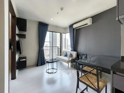 Modern living room with city view, featuring sleek furniture and air conditioning.