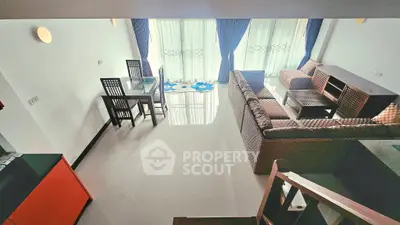 Spacious living room with modern furniture and large windows for natural light.