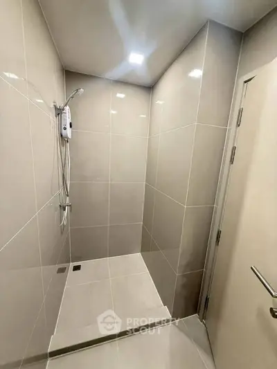 Modern bathroom with sleek shower design and neutral tiles