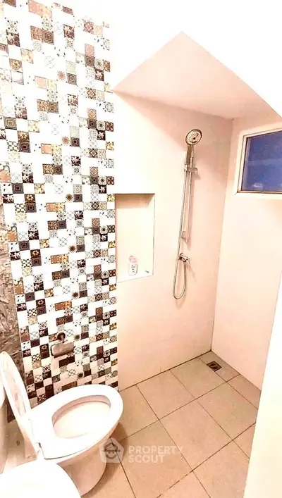 Modern bathroom with stylish tile design and shower area