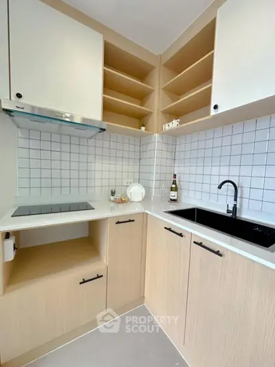 Modern kitchen with sleek design, featuring open shelves and stylish backsplash.