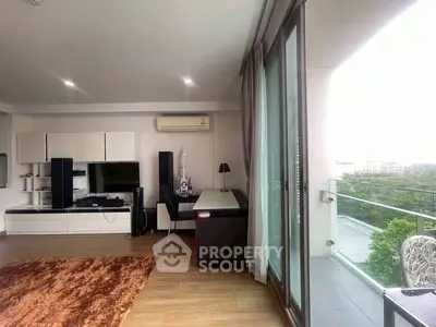 Spacious living room with balcony and modern decor, perfect for urban living.