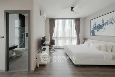 Modern bedroom with ensuite bathroom, featuring sleek design and natural light.