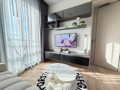 Modern living room with sleek furniture and natural light, featuring a stylish entertainment center and cozy decor.