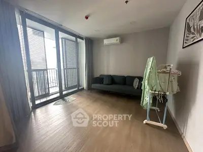 Spacious living room with balcony access and modern decor