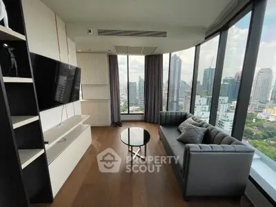 Stunning high-rise living room with panoramic city views and modern furnishings.