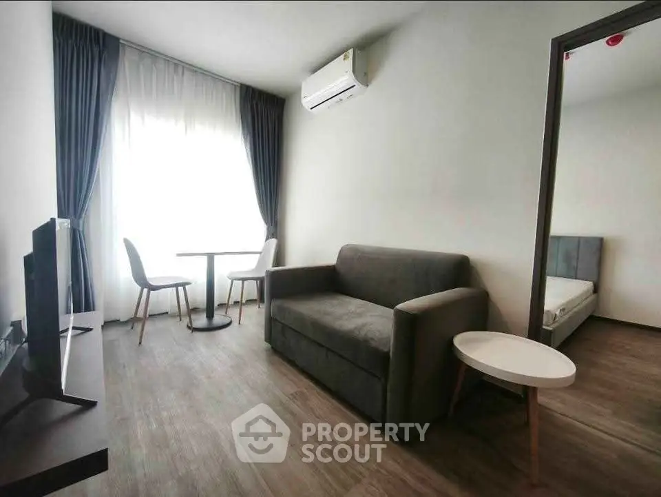 Modern living room with sleek furniture and natural light, perfect for urban living.