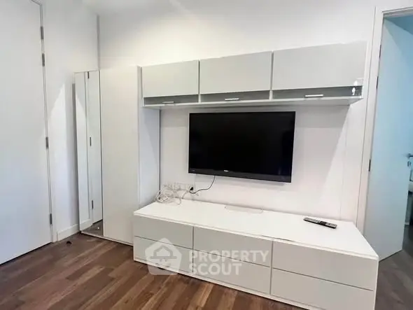 Modern living room with sleek TV unit and wooden flooring