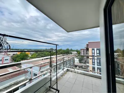 Spacious balcony with stunning city view in modern apartment