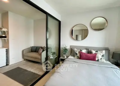 Modern bedroom with stylish decor and cozy seating area, perfect for relaxation.