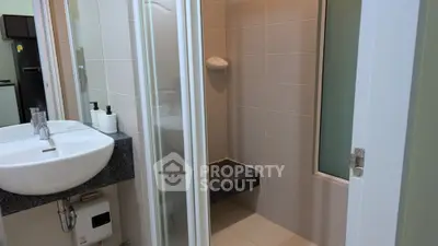Modern bathroom with sleek fixtures and glass shower enclosure