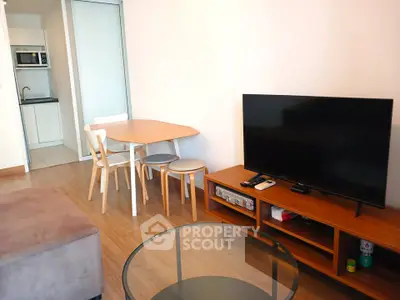 Modern living room with sleek furniture and open kitchen layout, perfect for cozy gatherings.