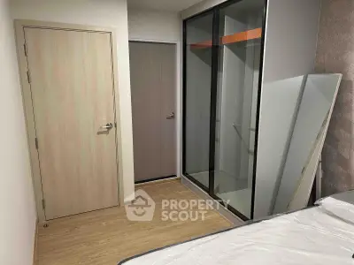 Modern bedroom with wooden flooring and sliding glass closet doors