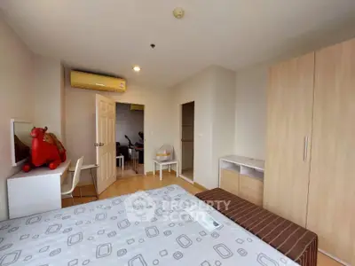 Spacious bedroom with modern furniture and natural light in a stylish apartment.