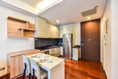 Modern kitchen with sleek cabinetry, stainless steel appliances, and cozy dining area.