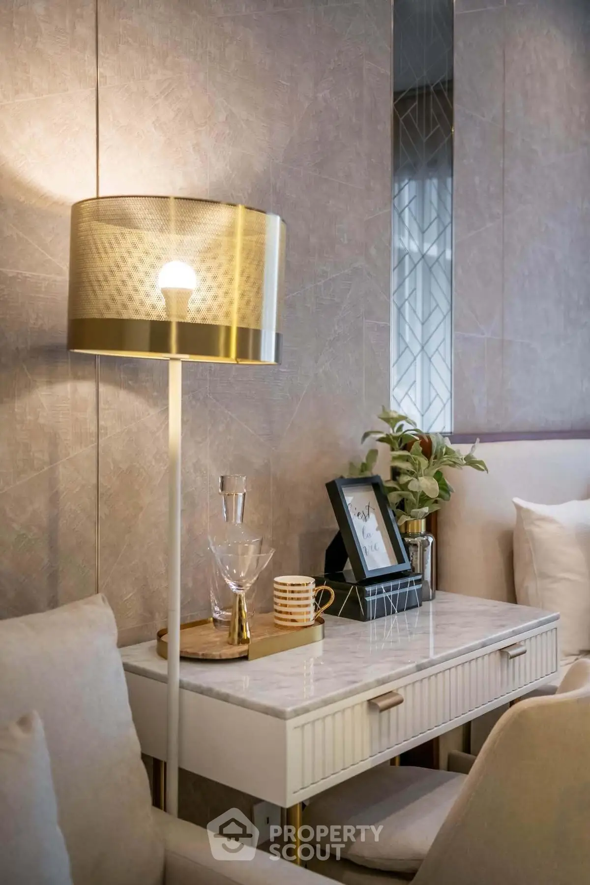 Elegant living room corner with stylish lamp and marble side table, perfect for modern interiors.