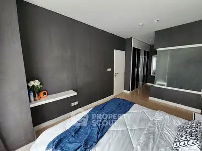 Modern bedroom with sleek design and cozy ambiance, featuring a stylish bed and elegant decor.
