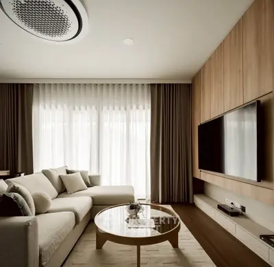 Elegant living room with modern decor and large TV, featuring a cozy sofa and stylish coffee table.