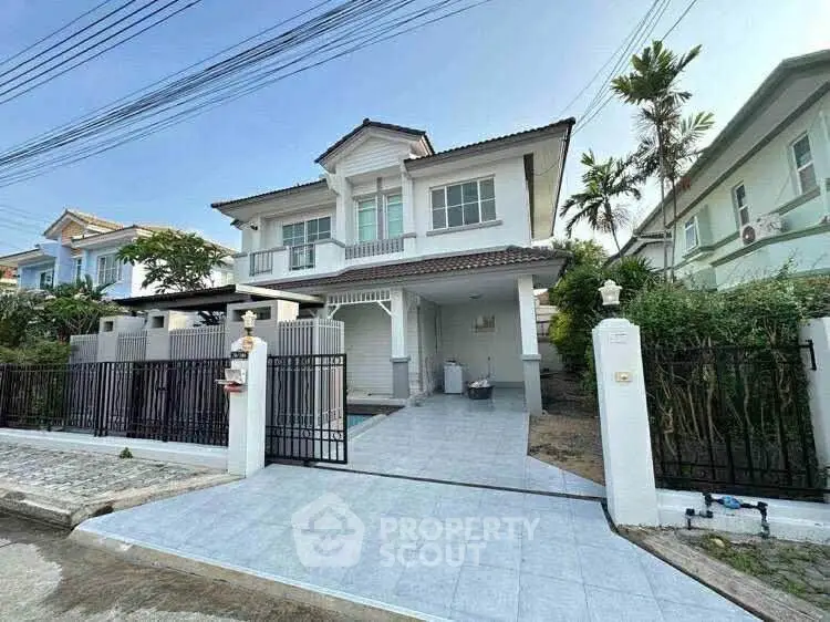 Charming two-story house with spacious driveway and modern exterior design.