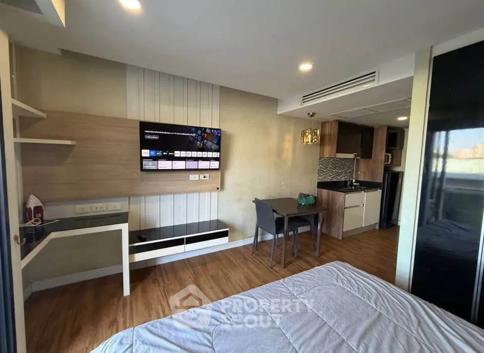 Modern studio apartment with open layout, featuring a cozy living area, kitchenette, and stylish decor.