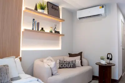 Cozy modern living room with stylish decor and air conditioning