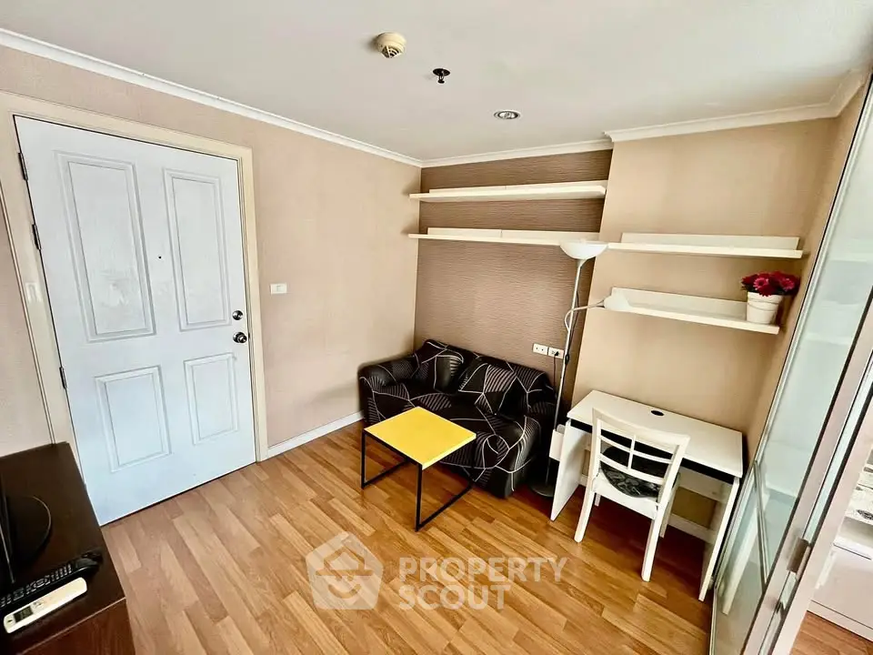 Cozy living room with modern furniture and wooden flooring in a stylish apartment.