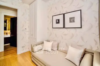 Chic living room with elegant wallpaper and cozy sofa, perfect for relaxation.