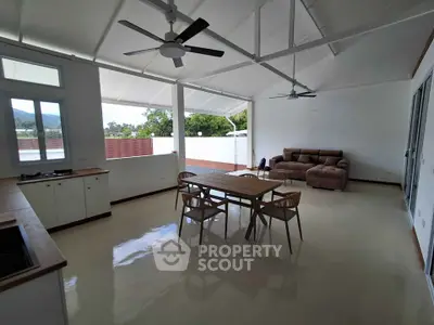 Spacious open-plan living room with modern kitchen and scenic views