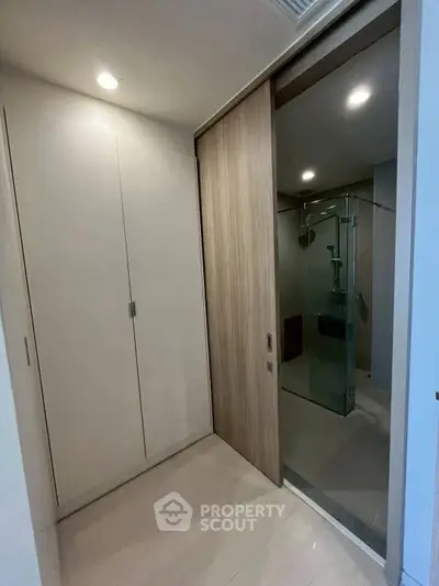 Modern bathroom with sleek glass shower and wooden sliding door