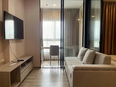 Modern living room with sleek furniture and natural light, featuring a cozy sofa and wall-mounted TV.