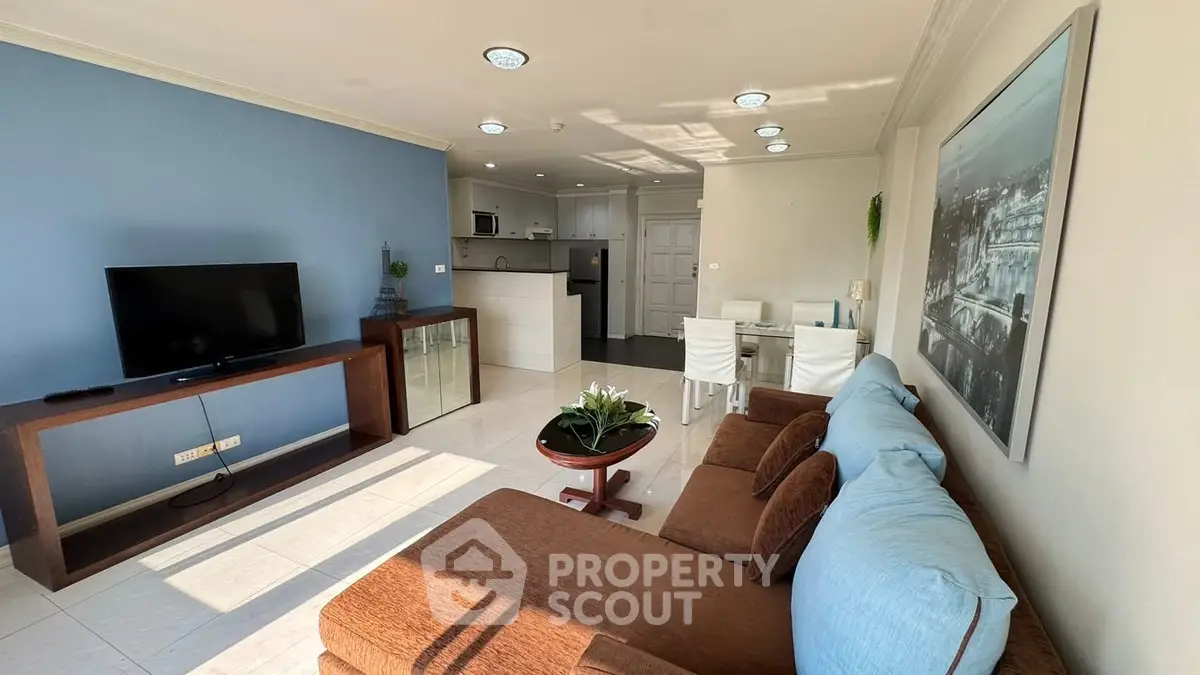 Spacious living room with modern decor and open kitchen layout