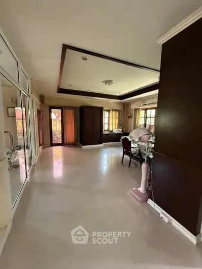 Spacious living room with elegant decor and large windows for natural light.