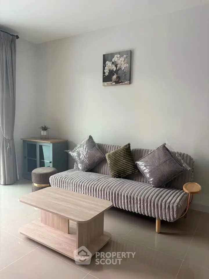 Modern living room with stylish sofa and elegant decor in a bright, inviting space.