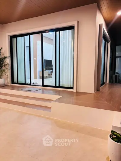 Modern home with sliding glass doors and elegant interior design, featuring a cozy living space and stylish decor.